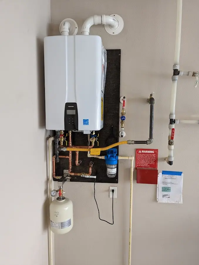 Professional plumber installing copper piping in a Hurstbourne home